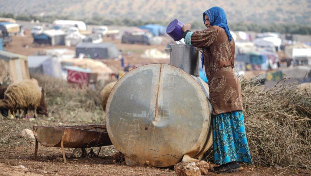 Archive/A Syrian woman fetching water.