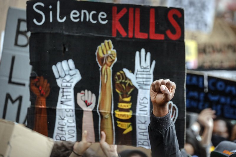 A protester shows his fist during a Black Lives matter protest in Parliament Square London, 2020 [AP]