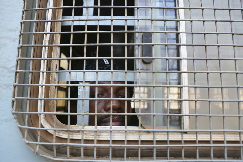 Hopewell Chin'ono seen through the window of a prison truck on 24 August 2020 [AP}