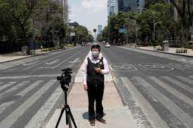 A journalist reporting during the Covid pandemic [Al Jazeera]