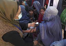 An internally displaced person from the northern provinces of Afghanistan has her blood pressure taken in Kabul, 2021.  [Rahmat Gul/AP]