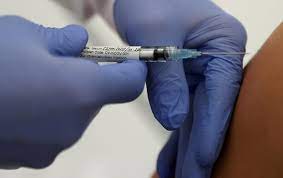 A vaccination is given to a volunteer in Germany. [Reuters/Kai Pfaffenbach]