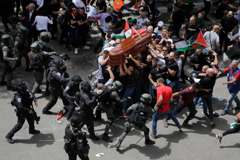 Israeli police hit mourners holding her coffin with batons, almost causing it to drop/Aljazeera.