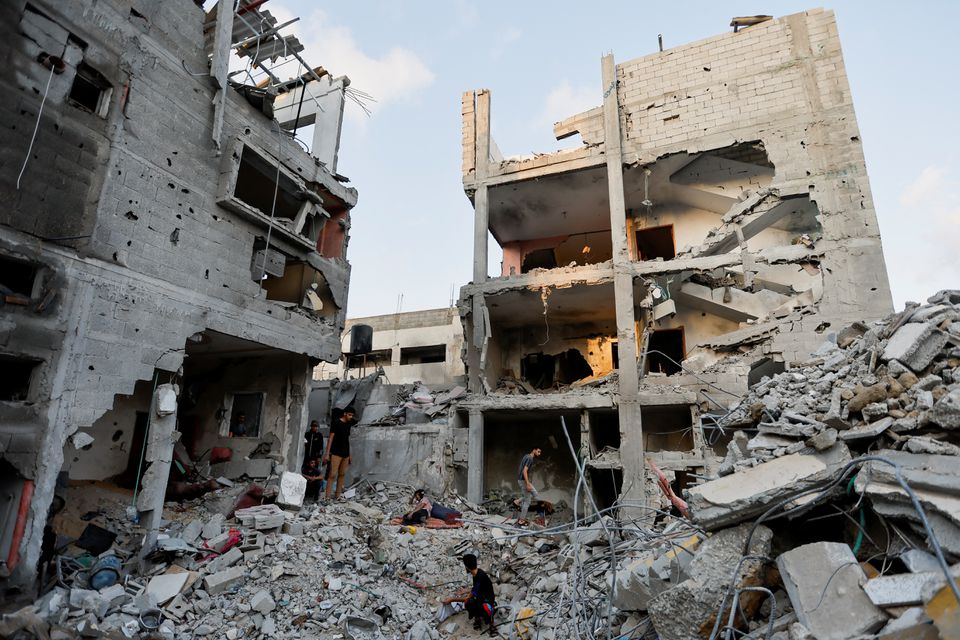 Palestinians gather at the scene where senior commander of Islamic Jihad militant group Khaled Mansour was killed in Israeli strikes, in Rafah in the southern Gaza Strip, August 7, 2022. REUTERS/Ibraheem Abu Mustafa.