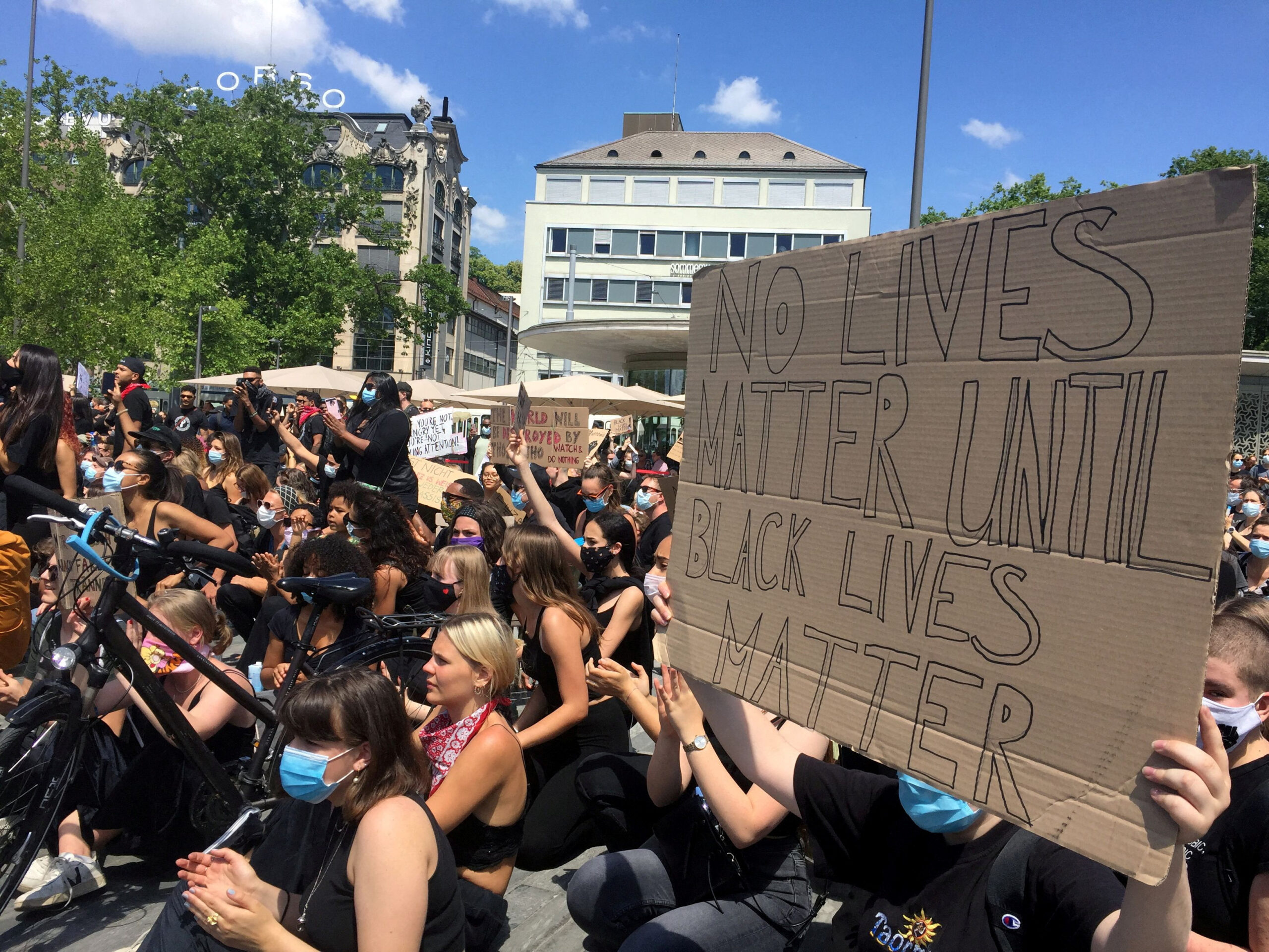 [1/3] People sit and hold banners during a Black Lives Matter protest, following the death of George Floyd in Minneapolis police custody, in Zurich, Switzerland, June 13, 2020. REUTERS/Michael Schields