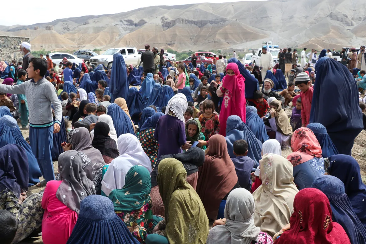 Displaced Afghan families after heavy flooding in the Khushi district of Logar, Afghanistan. [Stringer/Reuters]