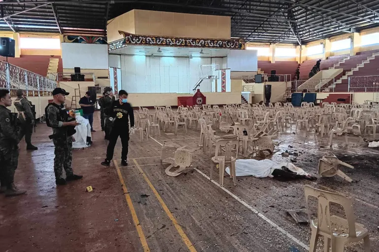 Security personnel survey the damage at Mindanao State University's gymnasium / Aljazeera [Provincial Government of Lanao Del Sur/Facebook]