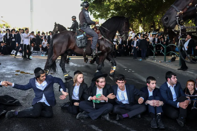 Ultra-Orthodox Jews block a highway in Bnei Brak as they protest against their conscription into the Israeli armed forces on April 1, 2024 [Oren Ziv/AFP]