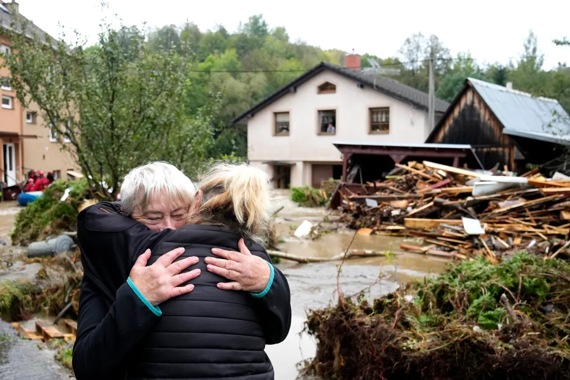 A resident hugs her relative after being evacuated from her flooded house in Jesenik, Czech Republic. [Petr David Josek/AP Photo]