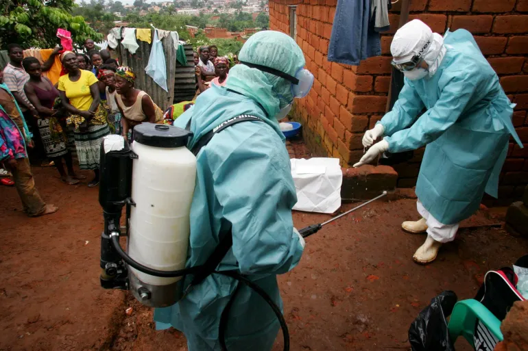 World Health Organisation officials examine the home of a suspected Marburg virus victim in the northern Angolan town of Uige [File: Reuters]