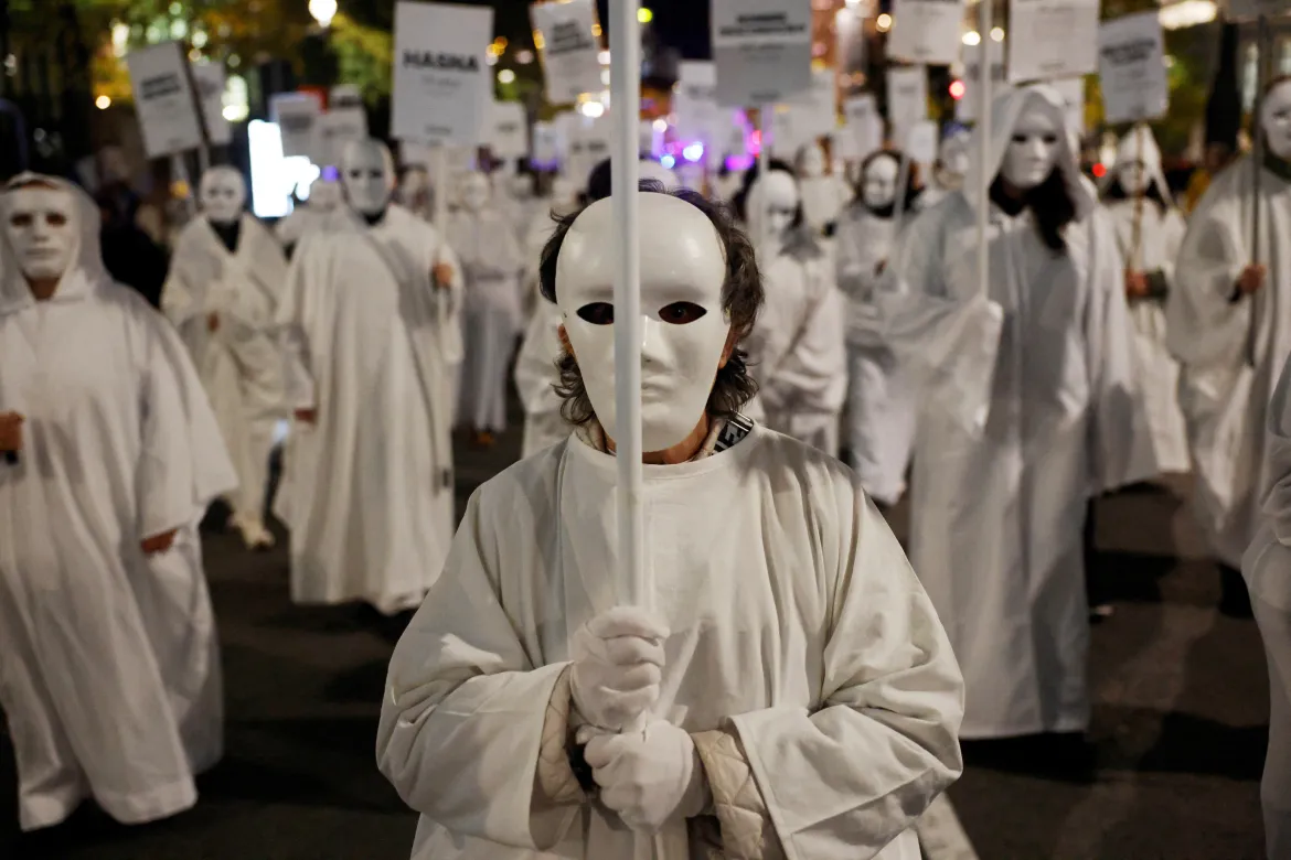 Demonstrators hold signs with the names of victims of gender-based violence, during a protest to mark the International Day for the Elimination of Violence against Women, in Madrid, Spain. [Susana Vera/Reuters]