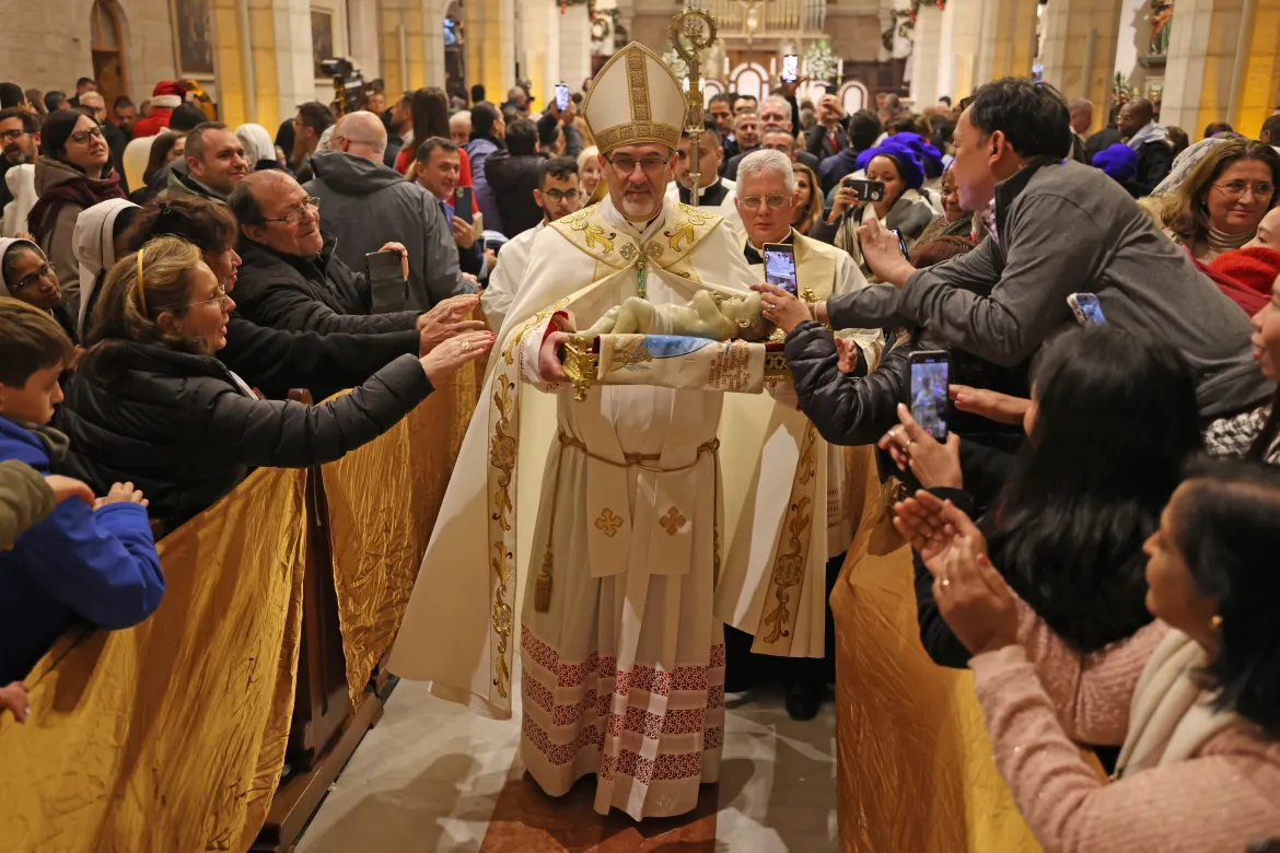 The acting Latin Patriarch of Jerusalem Pierbattista Pizzaballa leads a Christmas midnight Mass at the Church of the Nativity. [Ahmad Gharabli/Pool Photo via AP]