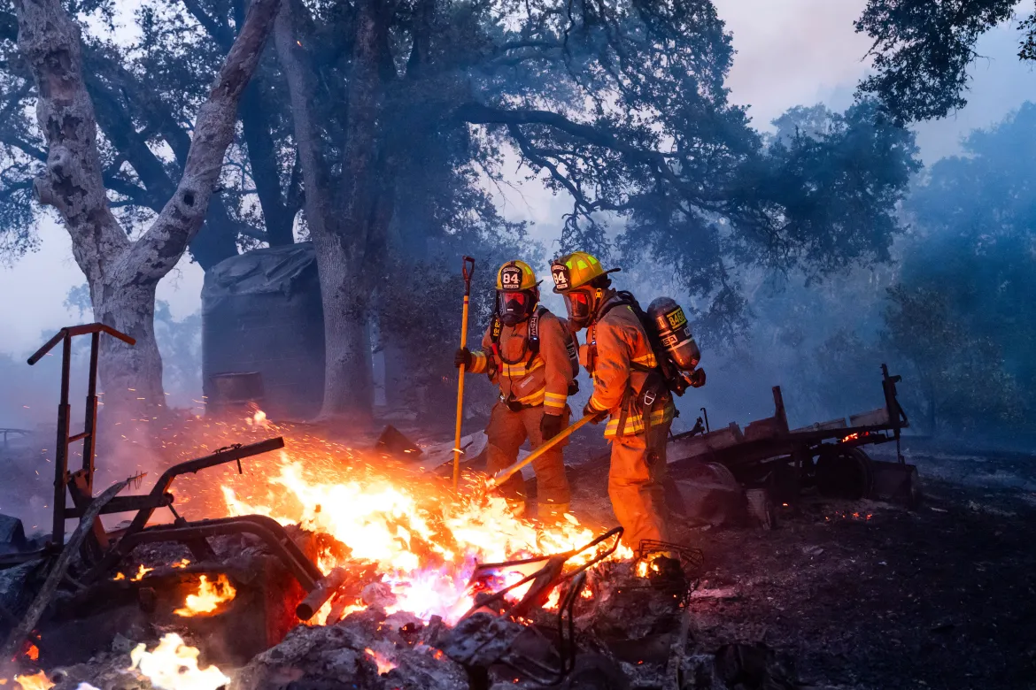 Firefighters working in sweltering conditions and steep terrain raced to douse spot fires. [Noah Berger/AP Photo]