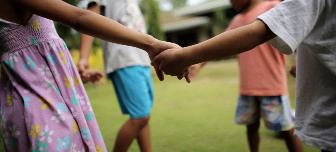 UNICEF/Joshua Estey Children play outside their home at a shelter in the Philippines.