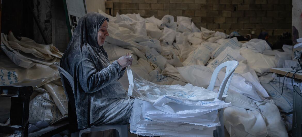 A woman in Gaza makes bags and sunshades from empty wheat flour bags.