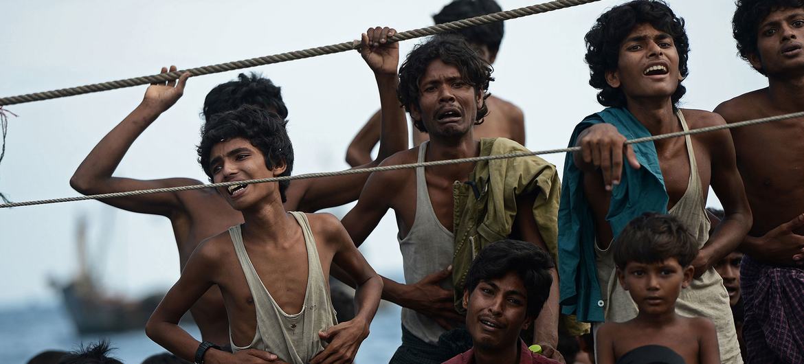 Stranded Rohingya boat people, desperate for food and water, sit on the deck of an abandoned smugglers' boat drifting in Thai waters off the southern island of Koh Lipe in the Andaman sea.