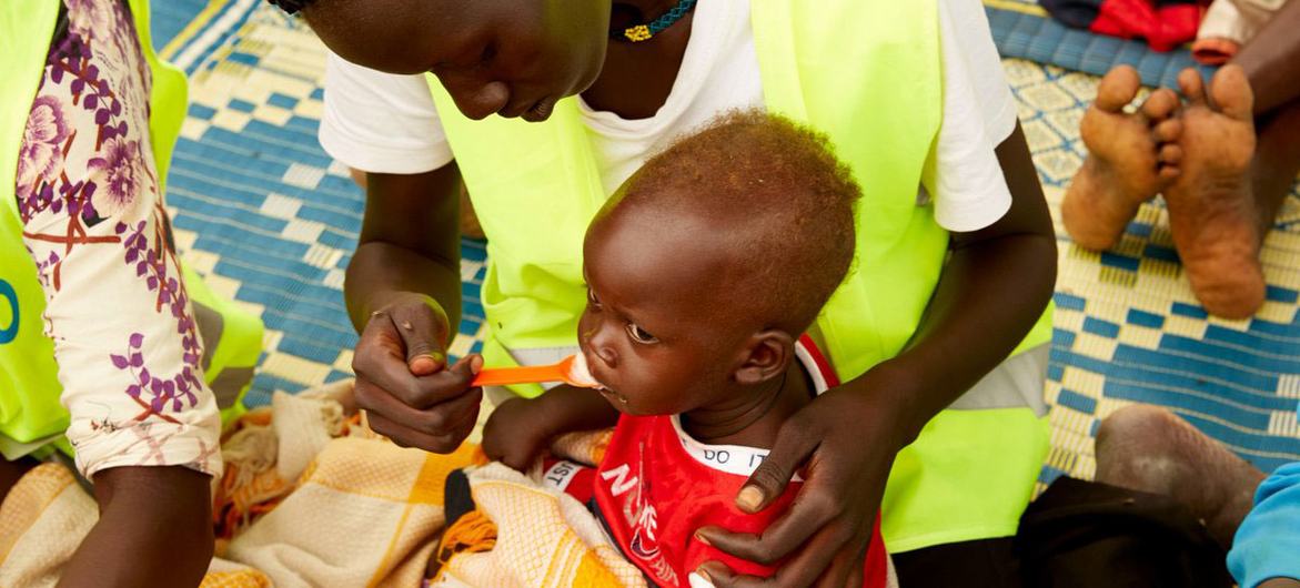 © UNICEF A child in South Sudan is fed by a healthcare worker.