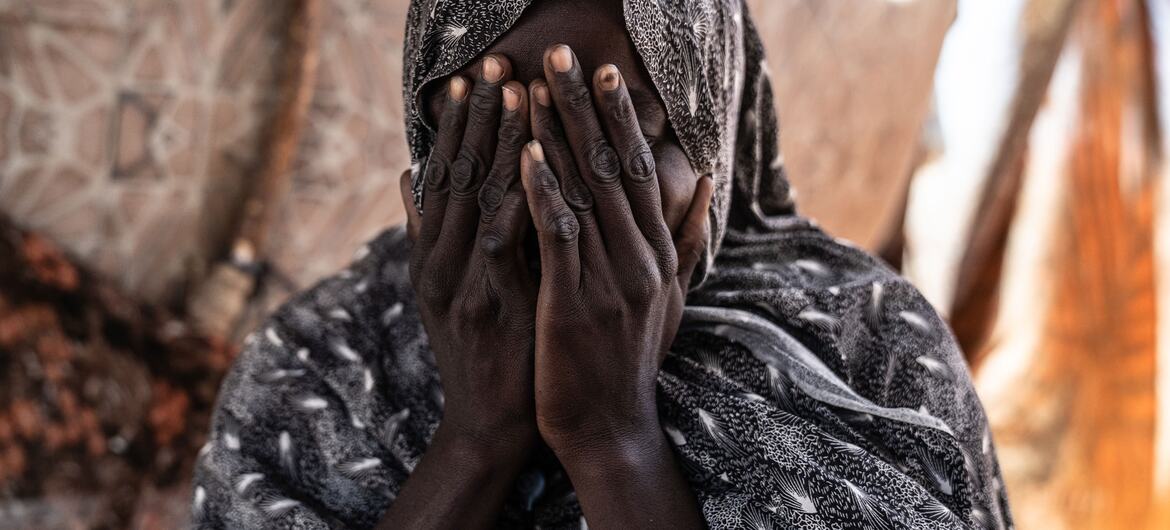 © UNOCHA/Giles Clarke A survivor of sexual violence covers her face with her hands in a camp for displaced people in Tawila, North Darfur.